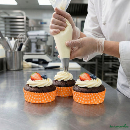 Restaurantware Panificio 4 Oz Round Polka-Dotted Hot Orange Paper Baking Cup - Ridged - 3 1/2" X 3 1/2" X 1"