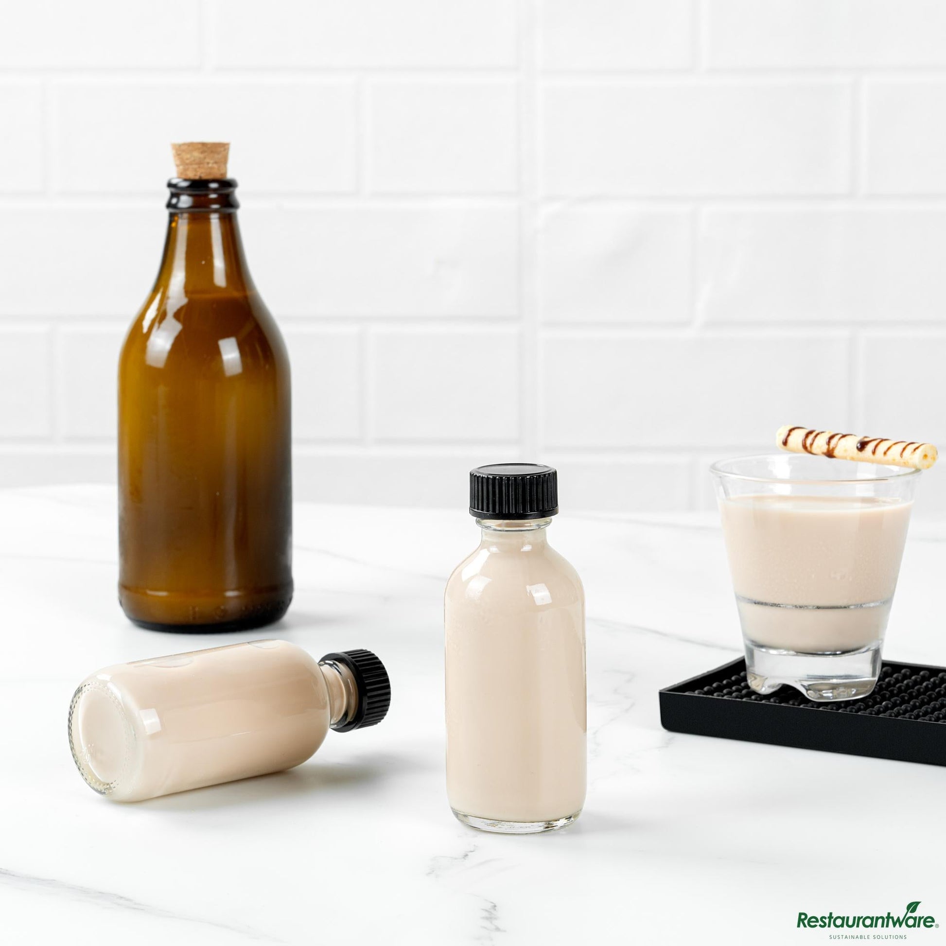 Wholesale Restaurantware 2 Oz Boston Round Clear Glass Bottle - with Black Phenolic Cap - 1.5" X 1.5" X 3.7"- Bulk